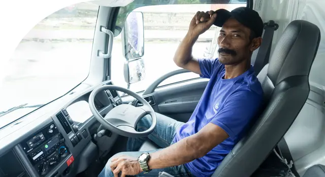 A Haroct driver at the wheel of his truck